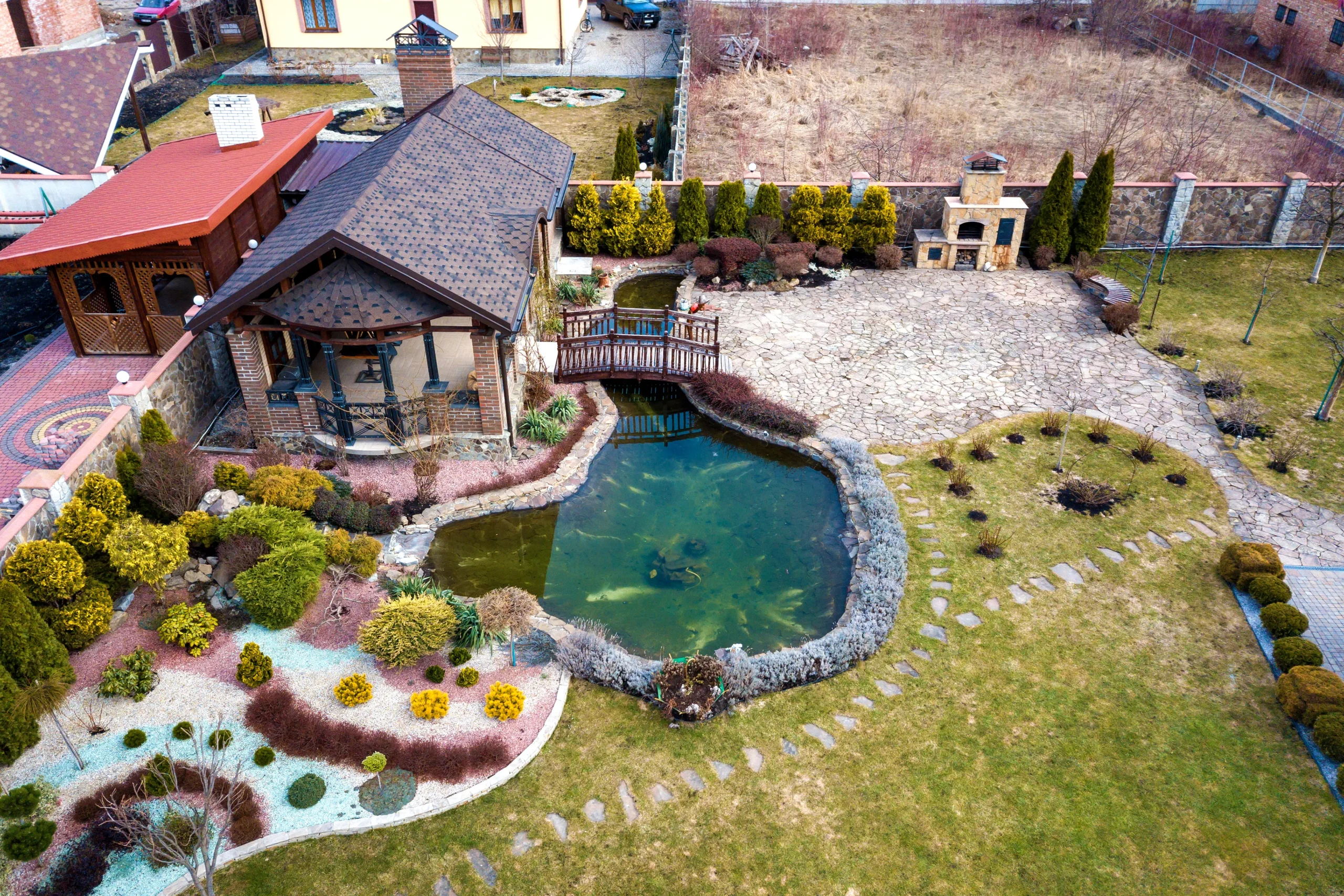 aerial view of landscaped backyard with pond 2026 03 16 00 41 57 utc scaled