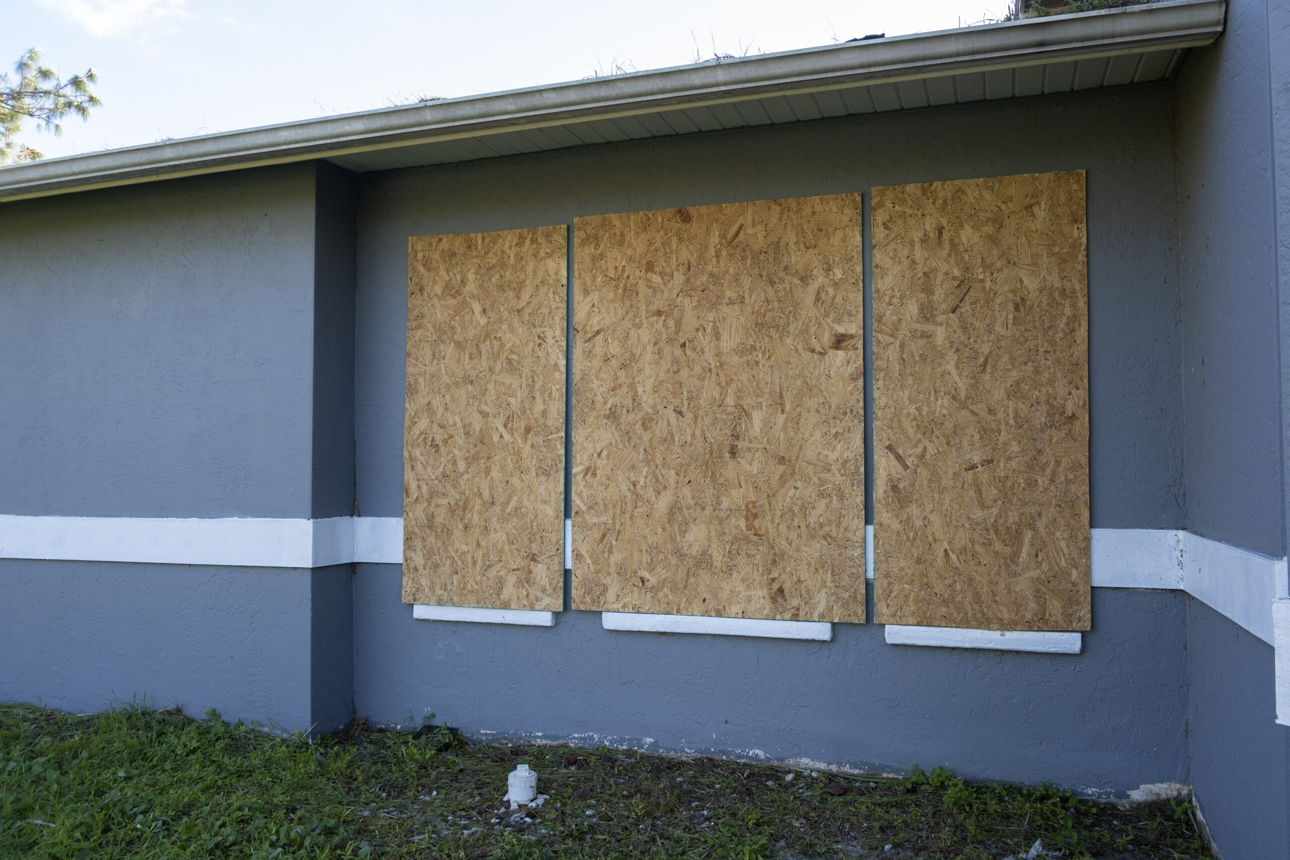 boarded windows on a gray suburban home 2026 09 22 23 33 20 utc scaled