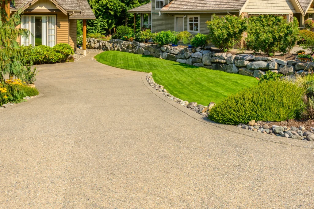 manicured lawn and stone wall next to driveway 2026 03 26 11 38 00 utc
