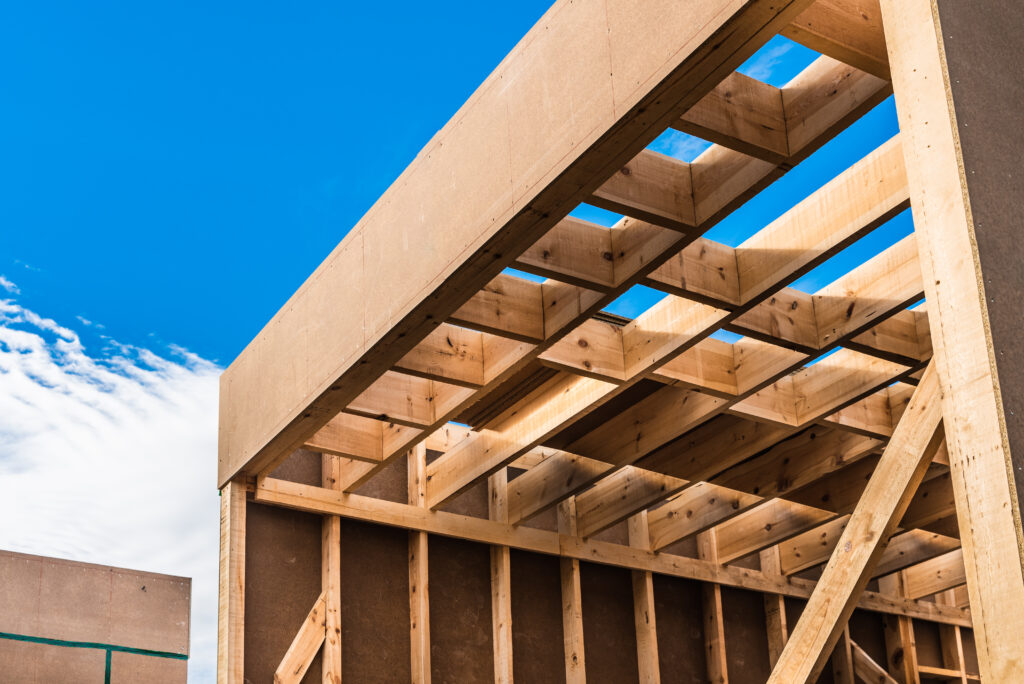 new construction framing against a bright blue sky 2026 03 10 03 13 50 utc